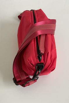 Nylon material with an adjustable web and leather strap to allow you to wear this 3 ways-around your waist, shoulder or as a crossbody. Fun voluminous shape makes this bag unique and sporty too! Go hands free for your life on the go. Sporty Nylon Shoulder Bag For On-the-go, Functional Nylon Shoulder Bag With Adjustable Handle, Red Nylon Shoulder Bag, Outdoor Nylon Shoulder Bag With Detachable Strap, Red Functional Shoulder Bag With Removable Pouch, Red Nylon Shoulder Bag With Zipper Closure, Functional Red Shoulder Bag For Travel, Functional Red Shoulder Bag For On-the-go, Functional Red Crossbody Shoulder Bag