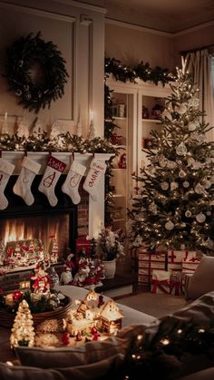 a living room decorated for christmas with stockings on the fireplace