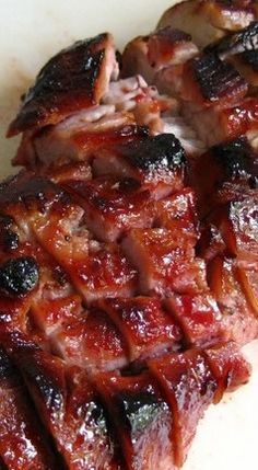 two pieces of meat sitting on top of a cutting board