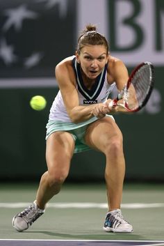 a female tennis player in action on the court during a match at the us open