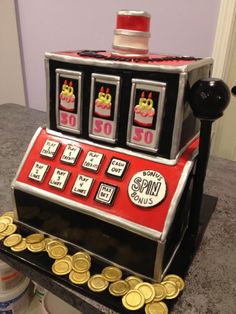 a cake made to look like a slot machine with gold coins around the rims