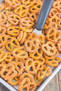 a pan filled with pretzels on top of a wooden table