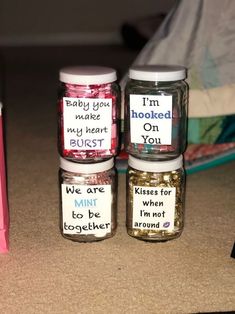 three jars with words written on them sitting next to each other