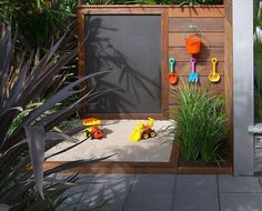 an outdoor play area with toys and sand