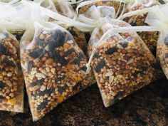 four bags filled with bird seed sitting on top of a counter