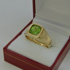 Gemstone: Peridot (from USA) Treatments: Untreated Specifications: 8x8mm, approx. 2.53 carats Color: As shown Clarity: Eye clean Cut: Cushion cut Weight: 16 grams. Ring size: 10, with all sizes available from 6.5 through 12 This is as fine and elegant a man's ring as you will ever find. The perfect blend of a fine gemstone matched up with a clean classic 14K yellow gold ring. Good solid weight, nicely distributed to give the ring an even weight so that it will not spin. There is nothing worse th Formal Yellow Gold Signet Ring With Birthstone, Formal Rings With Polished Peridot, Formal Peridot Rings With Polished Finish, Gold Peridot Rings For Formal Occasions, Formal Polished May Birthstone Signet Ring, May Birthstone Polished Finish Signet Ring For Formal Occasions, Formal May Birthstone Signet Ring With Polished Finish, Green Prong Set Signet Ring For Formal Occasions, Gia Certified Gold Gemstones For Formal Occasions