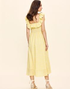 Louise New York creates its collection with the past and present in mind. Inspired by timeless glamour instead of trends, when you slip into a Louise New York dress, you carry all the confidence and carefree attitude that femininity can acclaim. The Annabelle Dress in Yellow Gingham is an effortless must-have for your summer wardrobe. This silhouette boasts a stretch shirred bodice and a lightweight, easy movement. Product Details Cotton. Made in NYC. Care Instructions Dry-clean only. Size & Fit Picnic Plaid Midi Dress With Ruffles, Plaid Midi Dress With Ruffles For Picnic, Fitted Gingham Midi Dress With Ruffles, Gingham Dress With Smocked Back For Garden Party, Spring Plaid Dress For Garden Party, Chic Fitted Midi Dress For Picnic, Chic Fitted Midi Dress For Picnics, Gingham Midi Dress For Garden Party, Chic Plaid Ruffled Dress