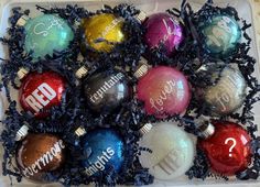 an assortment of christmas ornament ornaments in a plastic container with writing on them