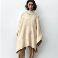 Ecru Cozy Sweater Poncho Oversized Chic Wool Poncho, One Size Cream Knit Outerwear, Cozy One Size Cream Outerwear, One Size Beige Soft Knit Sweater, Cream Winter Sweater One Size, Oversized Beige Wool Sweater, Oversized Cozy Poncho For Fall, Zara Cream Knitted Cardigan, One Size Beige Chunky Knit Sweater