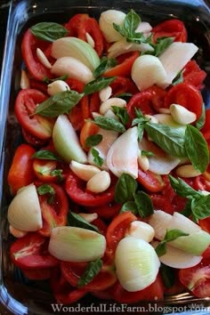 tomatoes, onions and basil in a glass dish