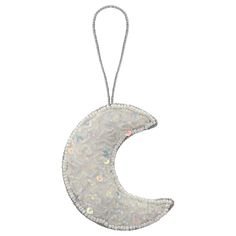 a white ornament hanging from a string on a white background with an image of the moon