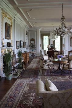 a living room filled with furniture and a chandelier