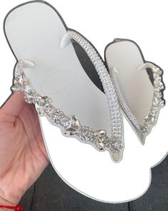 Summer Wedding Shoes Silver Embellished, White Rhinestone Shoe Clips, Silver Rhinestone Flip Flops, Silver Rhinestone Open Toe Flip Flops, Silver Open Toe Flip Flops With Rhinestones, Glamorous Flat Sandals For Wedding, Silver Round Toe Flip Flops For Party, Silver Open Toe Flip Flops For Party, Embellished Wedding Sandals For Summer