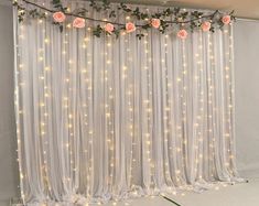 the curtain is decorated with flowers and lights