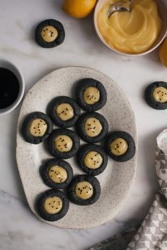 some cookies are sitting on a plate next to oranges