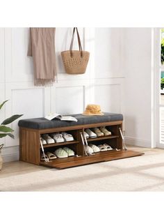 a wooden bench with shoes on it in front of a door