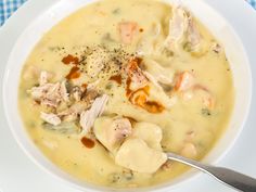 a white bowl filled with chicken and dumpling soup