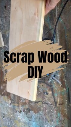 a person holding a piece of wood with the words scrap wood diy on it