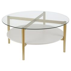 an oval glass table with gold legs and a white top, on a white background