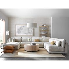 a living room filled with furniture and a white rug on top of a hard wood floor