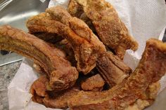 fried chicken strips are in a basket on the table