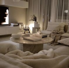 a living room filled with furniture and a flat screen tv mounted to the side of a wall