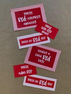 three red and white tags with words on them