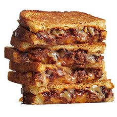 three grilled sandwiches stacked on top of each other in front of a white background