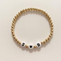 This listing is for one beaded bracelet (sterling silver, 14k gold or 14k rose gold) with your choice of letters for initials and a black heart bead. Please letters you want and your wrist size in the notes at check out. Kids size is 5 inches Bracelets are stretchy. Sizing- Please make sure to measure your wrist correctly before placing an order. To measure, measure snug and add 1/2 inch to that number. For example if your wrist measures 6 inches you want to purchase a size 6 1/2. Buyer is respo Classic Personalized Beaded Bracelets As Gift, Classic Personalized Beaded Bracelets For Gifts, Classic Personalized Beaded Bracelets For Everyday, Elegant Bracelet With Round Letter Beads, Minimalist Personalized Jewelry With Round Beads, Elegant Personalized Stretch Bracelet With Round Beads, Minimalist Letter Beads Stretch Bracelet As Gift, Minimalist Letter Beads Stretch Bracelet Gift, Adjustable Rose Gold Beaded Bracelet With Letter Beads