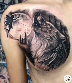 a man's chest with a wolf and moon tattoo on the side of it