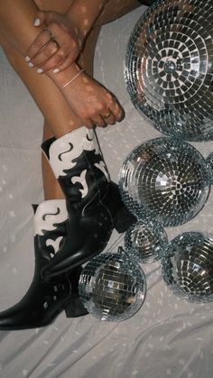 a woman's legs with disco balls and boots