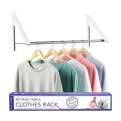 a rack with clothes hanging on it next to a woman