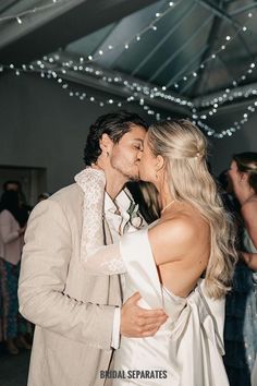 a bride and groom kissing on the dance floor