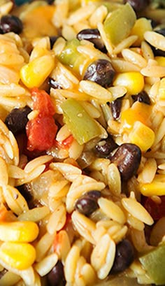 a bowl filled with rice, beans, and vegetables on top of a wooden table