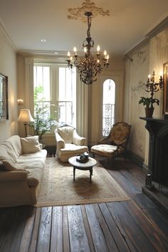 a living room filled with furniture and a chandelier