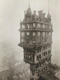 an old building with many windows and balconies in the middle of a city