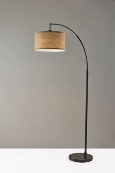 a lamp that is sitting on top of a white table next to a gray wall