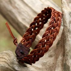 Featuring a handwoven design by local Thai artisans, this wristband bracelet is crafted from leather cord in a brown color. Chaloemphon presents the adjustable bracelet, closing with a silver button that is handcrafted by Karen hill tribe silversmiths. Woven Leather Bracelet, Brown Hand Wrapped Artisan Braided Bracelet, Artisan Brown Hand Wrapped Braided Bracelet, Brown Leather Braided Bracelet As Gift, Brown Leather Strap Braided Bracelet Gift, Adjustable Brown Leather Braided Bracelet, Adjustable Leather Strap Jewelry With Waxed Cord, Brown Waxed Cord Bracelet, Rustic Adjustable Leather Strap Bracelets