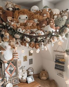 a room filled with lots of stuffed animals hanging from the ceiling and decorations on the wall