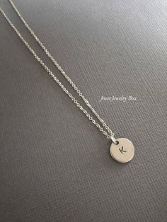 Simple disc necklace with initial. Hand stamped initial charm is on an 18'' stainless steel chain with lobster clasp. *10mm stainless steel disc *Stainless steel chain *Handmade with love <3 Like Jmesjewelrybox on Facebook for updates on new jewelry, upcoming sales and giveaways! Plus Facebook fans save 5% :D Find the coupon code on Jmesjewelrybox's cover photo https://www.facebook.com/Jmesjewelrybox Minimalist Everyday Round Initial Necklace, Simple Initial Pendant Charm Necklaces, Simple Tiny Initial Pendant Charm Necklaces, Simple Tiny Initial Pendant Charm Necklace, Minimalist Round Hand Stamped Charm Necklaces, Hypoallergenic Minimalist Initial Necklace For Everyday, Everyday Hypoallergenic Minimalist Initial Necklace, Minimalist Personalized Round Disc Charm Necklaces, Minimalist Round Disc Charm Necklace For Personalized Gift