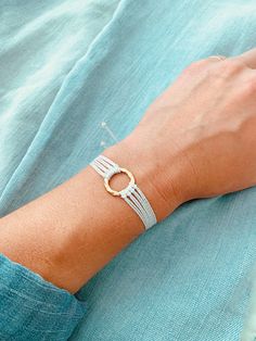 This boho-style string bracelet is super cute and would make a great gift! The bracelet is adjustable to fit almost any wrist size! Stack it with other bracelets, or wear it by itself! It is perfect for everyday wear!  ✦ PLEASE NOTE ✦  When you first receive this bracelet, it may feel slightly waxy, which may make it more difficult to adjust. The waxy texture does not last. After a day or two of wearing, the waxy texture will fade, and it will be much easier to adjust. It will still be waterproof and comfortable! ∙ ∙ ∙ ∙ ∙ ∙ ∙ ∙ ∙ ∙ ∙ ∙ ✦ BRACELET MATERIALS ✦  * White High-Quality Waxed Polyester Cord (This cord is waterproof!) * Gold Circle Charm ∙ ∙ ∙ ∙ ∙ ∙ ∙ ∙ ∙ ∙ ∙ ∙ ✦ QUESTIONS/PROBLEMS ✦ If you have any questions, please feel free to ask! I hope to provide a positive experience for m Dainty Adjustable Bracelets For Festivals, Dainty Adjustable Cord Bracelet, Dainty Bracelet With Adjustable Cord, White Braided Bracelet With Adjustable Cord, Adjustable Dainty Braided Bracelet, White Bohemian Bracelet With Adjustable Length, White Adjustable Wrap Bracelet, White Hand-wrapped Friendship Bracelets, Adjustable White Braided Bracelet