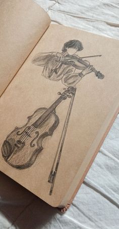 an open book with a drawing of a girl playing the violin on it's cover