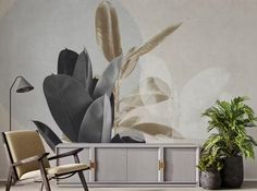 a living room with a plant and a wall mural