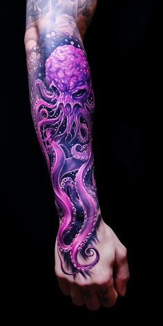 a person with tattoos on their arm and hand holding an octopus tattoo in purple ink