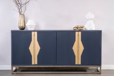 a blue and gold sideboard with decorative items on top