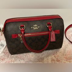 Brown Coach Hand Bag With Red Trimming Red On Inside Comes With Long Red And Brown Strap Gold Hardware Coach Print Designer Coach Bag In Burgundy, Designer Red Bags With Detachable Handle, Designer Burgundy Coach Bag, Luxury Red Crossbody Satchel, Designer Red Tote Satchel, Designer Red Bags With Handles, Luxury Burgundy Coach Bag, Designer Red Satchel With Double Handle, Designer Red Satchel With Detachable Handle