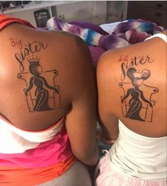 two women with tattoos on their backs that say big sister and little sister in black ink