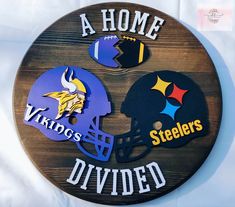 a wooden sign with two football helmets on it that says, a home is divided