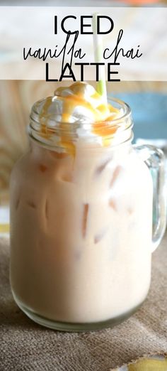 an iced drink with whipped cream and orange peels in a mason jar on a table