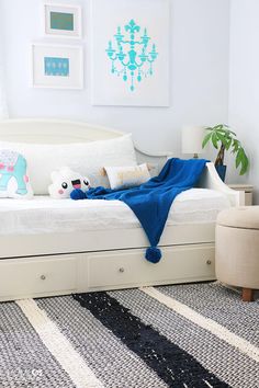 a bedroom with a white bed and blue blanket